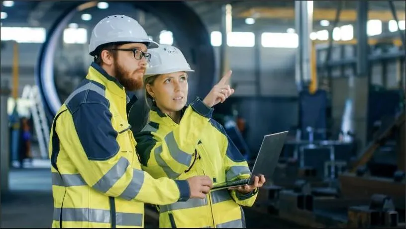 Facility team reviewing equipment data on a laptop