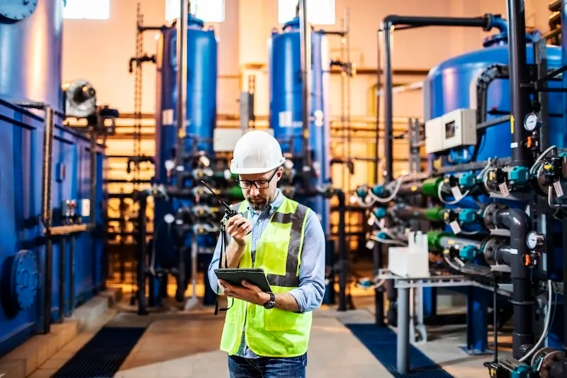 Maintenance technician using predictive condition monitoring on industrial equipment